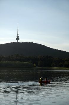 kayak with a woman and a boy, famous Telstra tower in background; Canberra - Australia