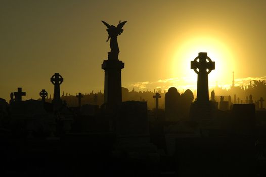 silent evening scene at an old cemetery, silhouettes of graves, crosses and statues, black and yellow dominant colors