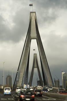 anzac bridge in sydney, dark cloudy sky, traffic