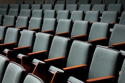 Rows of unoccupied seats in an empty auditorium or lecture hall