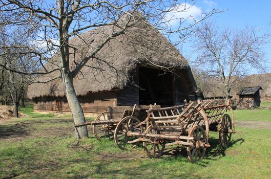 Farm carts in front of the barn.