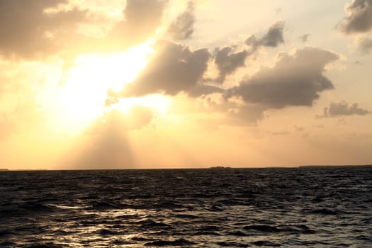 A dramatic sunset and the light and shadows from the clouds.