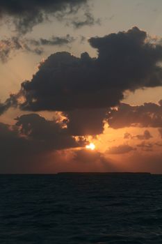 A dramatic sunset and the light and shadows from the clouds.