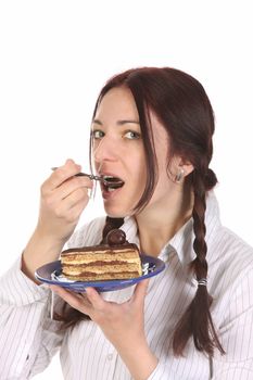 Beautiful woman eating piece of cake on white background