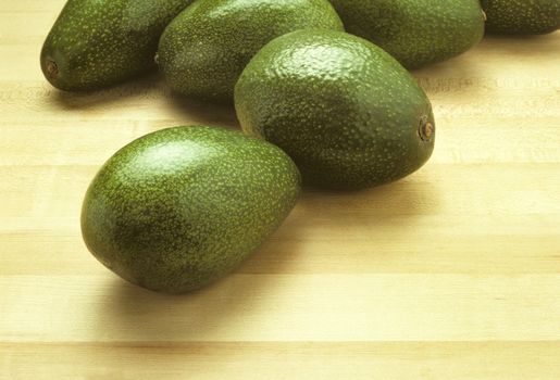 Avocados on a butcher block cutting board