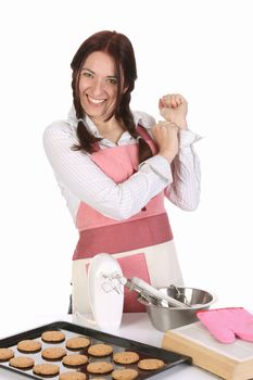 beautiful housewife with completed cakes on white background