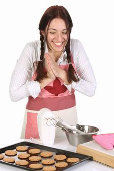 beautiful housewife with completed cakes on white background
