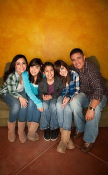 Attractive Hispanic Family Sitting on a Green Couch