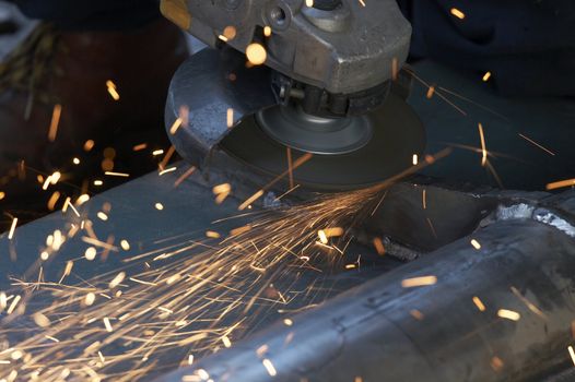 a picture of metal sparks coming from a grinder