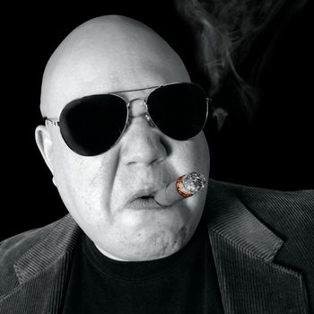 The Loan Shark, Boss, Head Honcho, Top Dog...  An image of the Man in charge, smoking a cigar.
