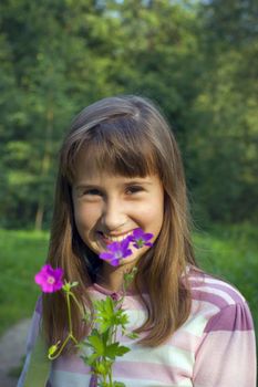 Portrait of girl with flower in summer time.