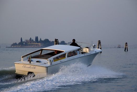 Travelers taking a boat ride from Venice to the Marco Polo Airport.