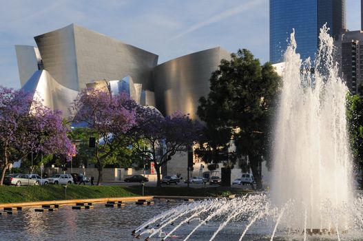 Los Angeles Philharmonic Orchestra venue (Walt Disney Concert Hall) with jacaranda trees and fountain in foreground