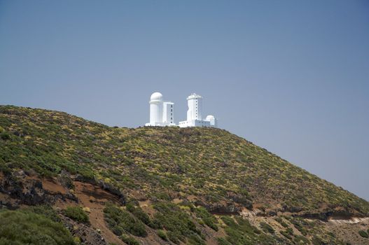 astrophysic white buildings on a green mountain