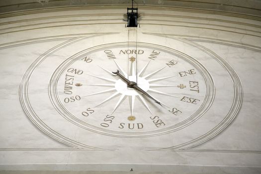very big compass on a wall