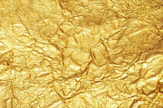 Crumpled gold foil textured background Horizontal