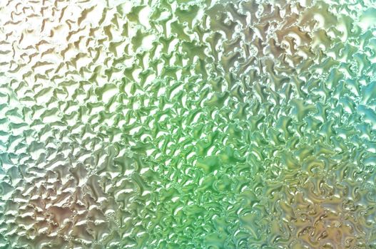 Water condensation on glass with color in background Horizontal