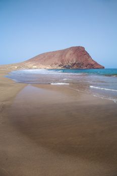 tejita beach with the red mountain at tenerife