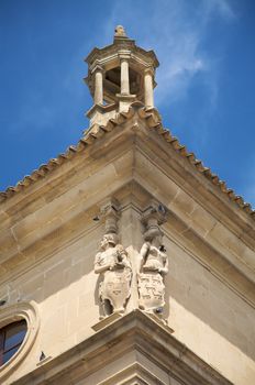 two sculptures at the corner in the cadenas palace in ubeda spain