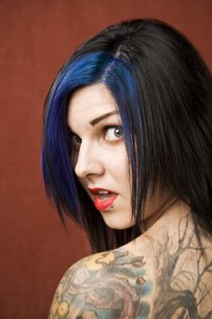 Pretty young woman with many tattoos 