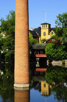 old city of Norrkoping with chimney in the water