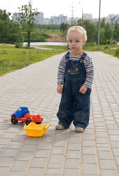 Sad boy with a broken toy truck