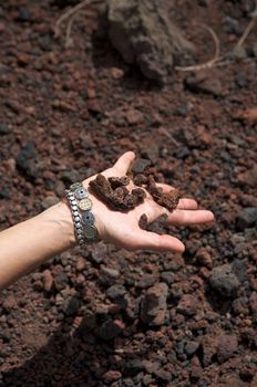 woman hand with volcanic stones