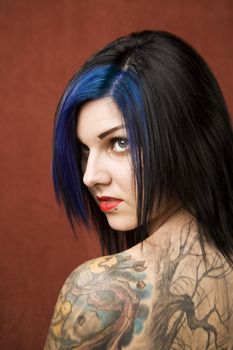 Pretty woman with black hair and many tattoos