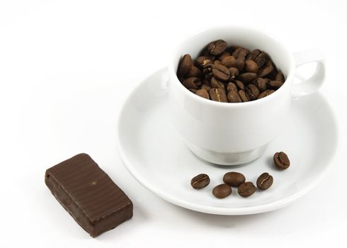 Cup with coffee beans and chocolate isolated over white background