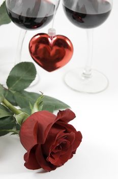 Beautiful red rose, heart and two glasses of wine