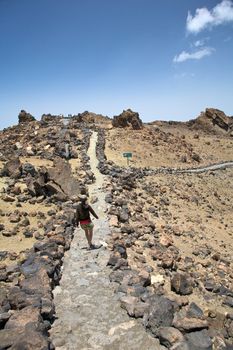 woman walking near teide volcano in tenerife spain