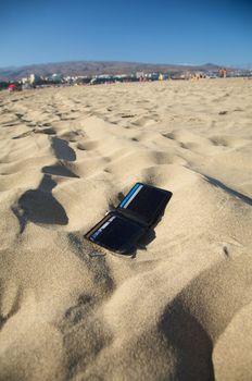 lost black leather wallet with four cards at the beach