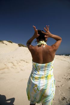 woman backwards at a beach next to tarifa in spain