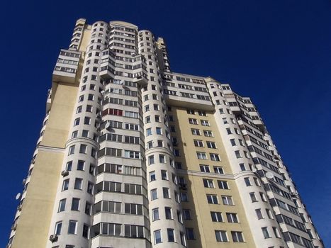 Yellow new high house on a blue background