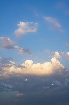 Lots of clouds of a beautiful summer sky. It is almost sunset.