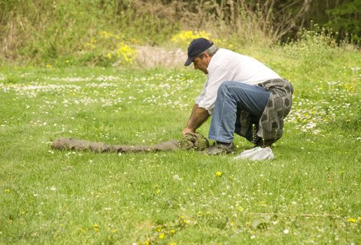 a man on a picnic is packing a blanket