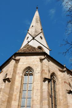 Detail of the belltower and the exterior of the apse of the ancient parish church of Gries,  Bolzano Italy