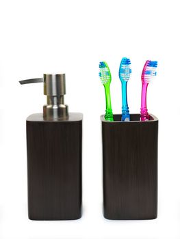 Toothbrushes in toothbrush holder isolated against a white background