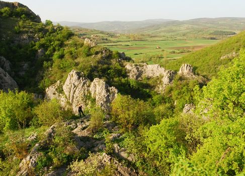 a girl is standing on a cliff