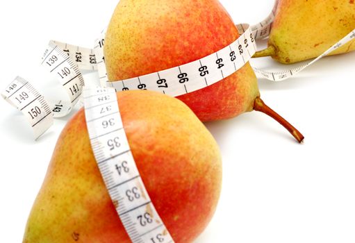 concept of healthy diet - three fresh pears and measuring tape