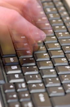 Fingers typing on a black laptop keyboard