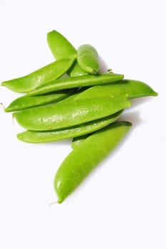Fresh washed Sugar Snap Peas on a light background.