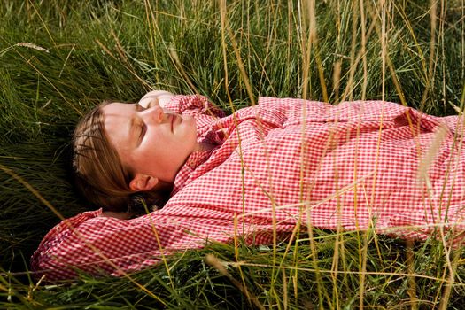 A farm girl relaxing in the grass