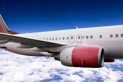 An airplane in flight over a blue sky