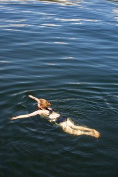 A woman swimming in fresh water