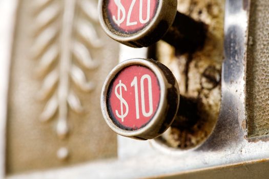 A ten dollar button on a retro cash register - shallow depth of field.