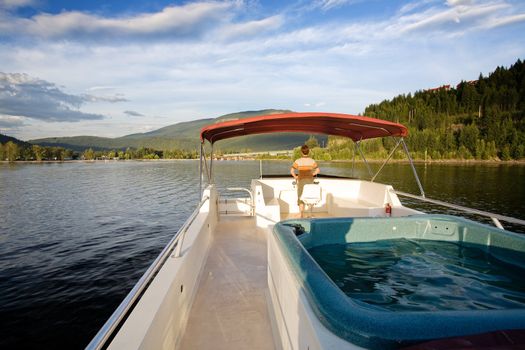 A hot tub on a luxury boat on a lake at sundown