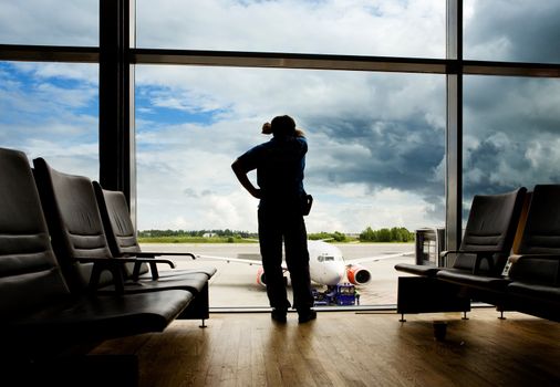 A male waiting sleeping in the airport