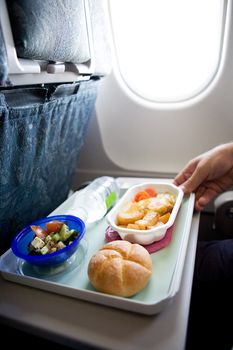 An airplane chicken and potatos meal