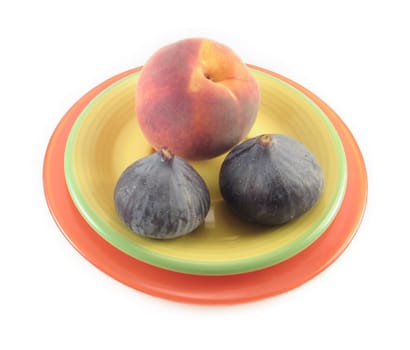 some peach and figs on a yellow plate 
